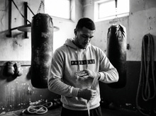 Load image into Gallery viewer, Physical Undercover Hoodie — getting ready — black and white editorial