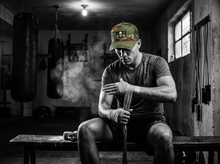 Load image into Gallery viewer, Physical Badge Trucker Hat — getting ready — black and white editorial