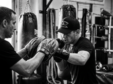 Load image into Gallery viewer, Combat Sports Low Profile Mesh Back Trucker Hat — coaching — black and white editorial