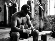 Load image into Gallery viewer, PHYSICAL Grappler Low Profile Mesh Back Trucker Hat — getting ready — black and white editorial