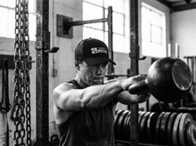 Load image into Gallery viewer, PHYSICAL Wrestler Low Profile Mesh Back Trucker Hat — lifting — black and white editorial
