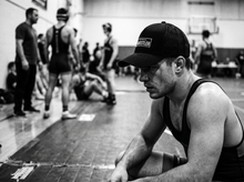 Load image into Gallery viewer, PHYSICAL Wrestler Low Profile Mesh Back Trucker Hat — tournament — black and white editorial